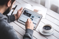 Man reading from a tablet